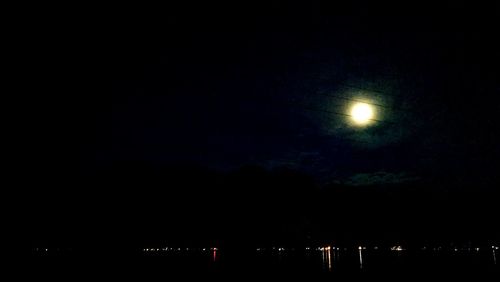 Low angle view of silhouette lights against clear sky at night