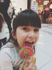 Close-up portrait of girl eating candy