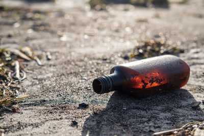 Garbage on the beach. bottle in the sand on a sunny day. environmental pollution. human trash.