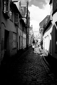 Narrow street amidst buildings in town