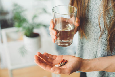 Midsection of woman holding drink