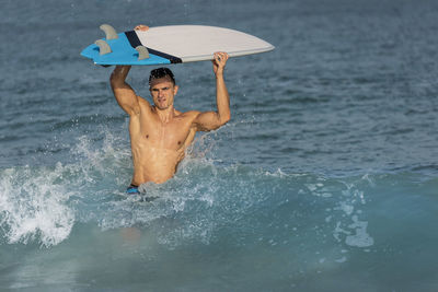 Full length of shirtless man in sea