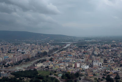 High angle view of cityscape against cloudy sky