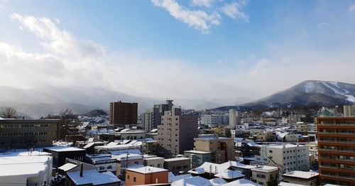 Aerial view of townscape against sky