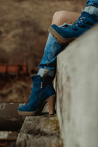 Low section of woman in high heels relaxing outdoors