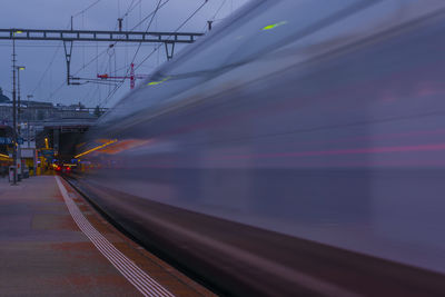 Blurred motion of train at railroad station