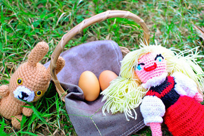 Close-up of multi colored stuffed toys with eggs on grass