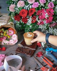 High angle view of hand holding bouquet of people