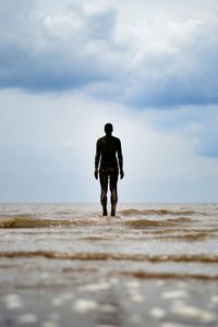 Statue on sea at beach
