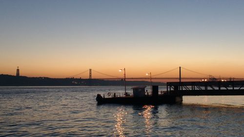 Silhouette of suspension bridge at sunset