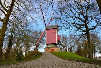 Built structure by trees against sky