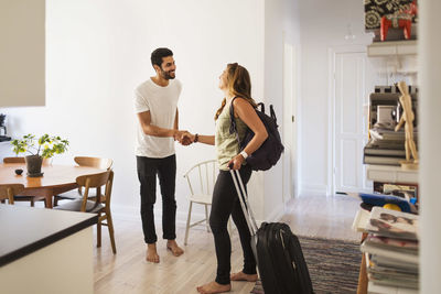 Young couple standing on wall