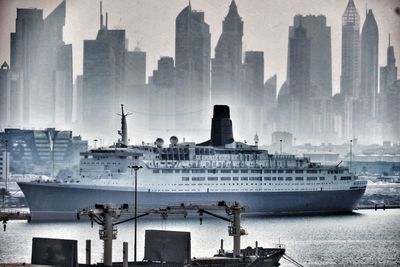 Cityscape by sea against sky