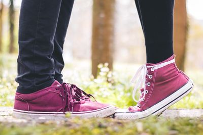 Low section of couple standing outdoors