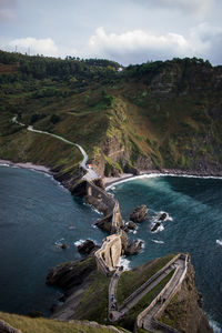 High angle view of walkway on rock formation amidst sea