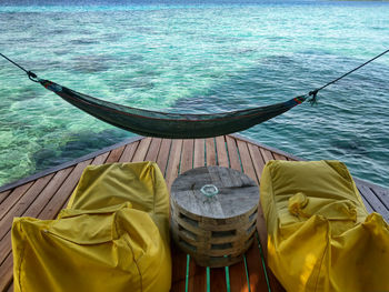 High angle view of lounge chairs by sea