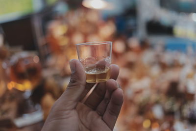 Cropped hand holding glass