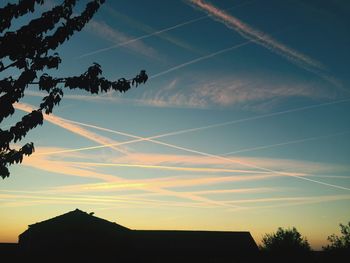 Low angle view of silhouette trees against sky at sunset