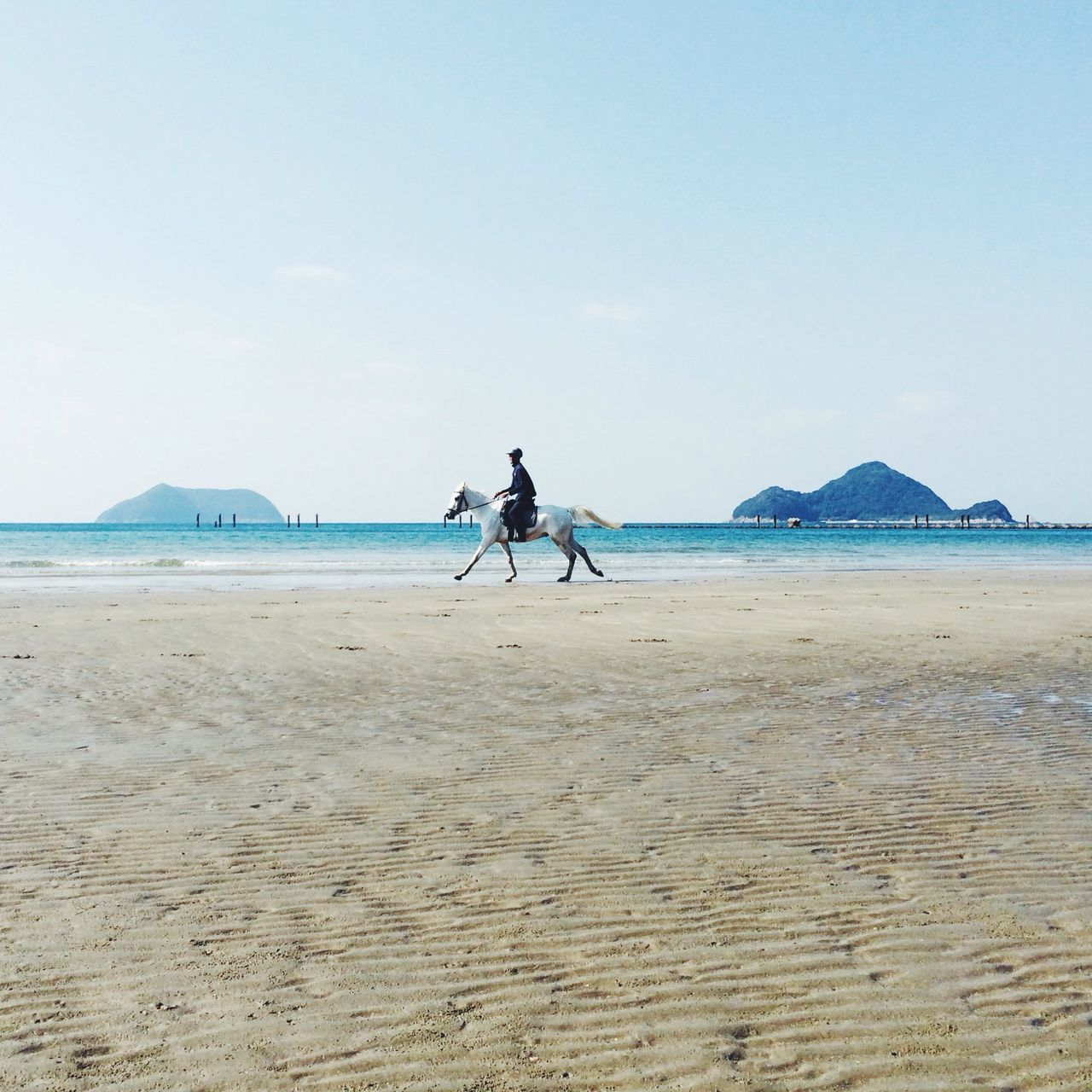 beach, sand, sea, leisure activity, lifestyles, men, water, full length, shore, riding, vacations, transportation, horizon over water, bicycle, clear sky, mode of transport, sky, travel