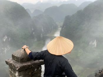 Rear view of person by mountains