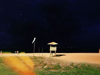 Built structure on field against sky at night