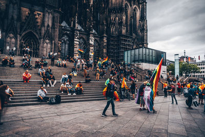 People walking on street against buildings in city