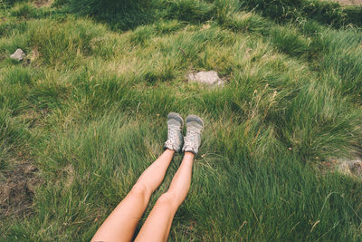 Low section of woman on field