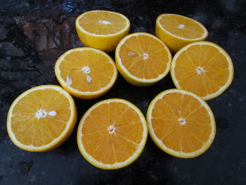 High angle view of sliced oranges on wet table