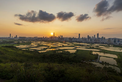 Scenic view of buildings against sky during sunset