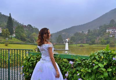 Woman standing on mountain against plants