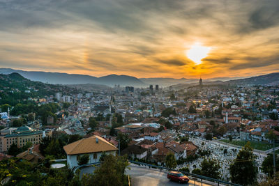 Aerial view of townscape against sky during sunset