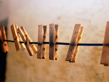 Close-up of clothespins hanging on clothesline