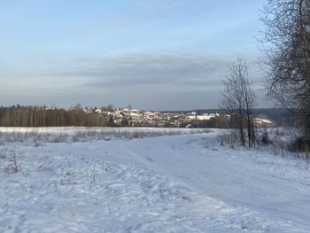 Snow covered field against sky