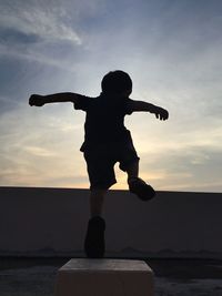 Silhouette of woman against sky