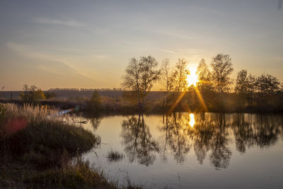 Scenic view of lake against sky during sunset