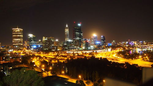 High angle view of illuminated buildings in city at night