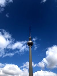 Low angle view of communications tower against sky