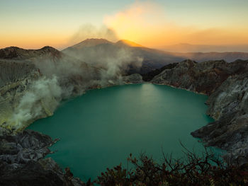 High angle view of crater lake against sky during sunset