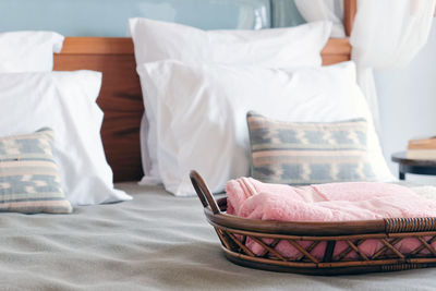 Close-up of towel in basket on bed at home