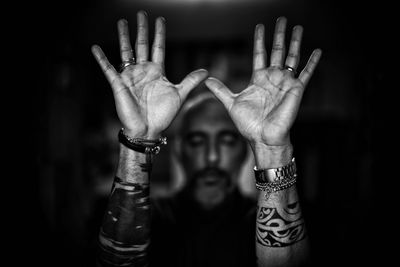 Close-up of human hand against black background