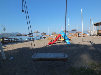 Sailboats in sea against clear sky