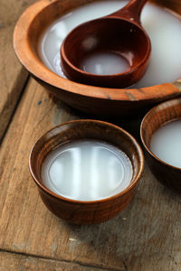 Sikhye or dongdongju, korean sweet rice drink, served on wooden bowl