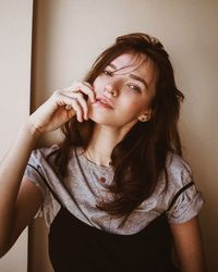 Close-up portrait of young woman at home