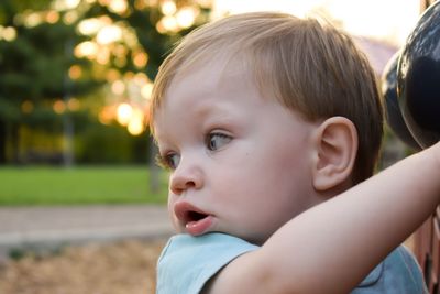 Close-up of cute baby boy standing at yard