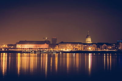 Illuminated city at waterfront