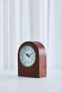 Close-up of clock on table