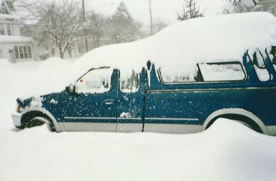 Cars parked on snow covered road