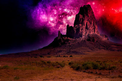 Scenic view of rock formation against sky at night