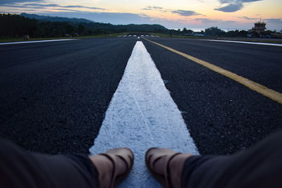 Man lying on road in city