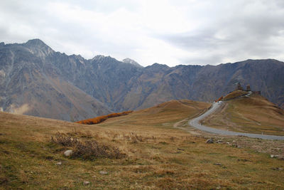 Autumn landscape with gergeti trinity church on a background of caucasus mountains, georgia.